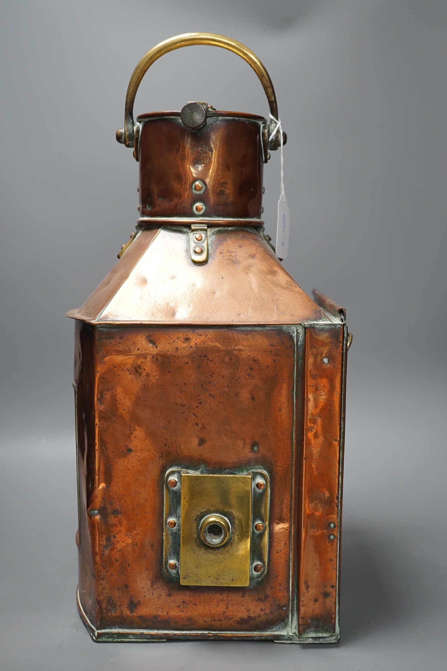 A copper ship’s port lamp, manufactured by Telford.Grier & Mackay, Glasgow, 1918, 42 cms high